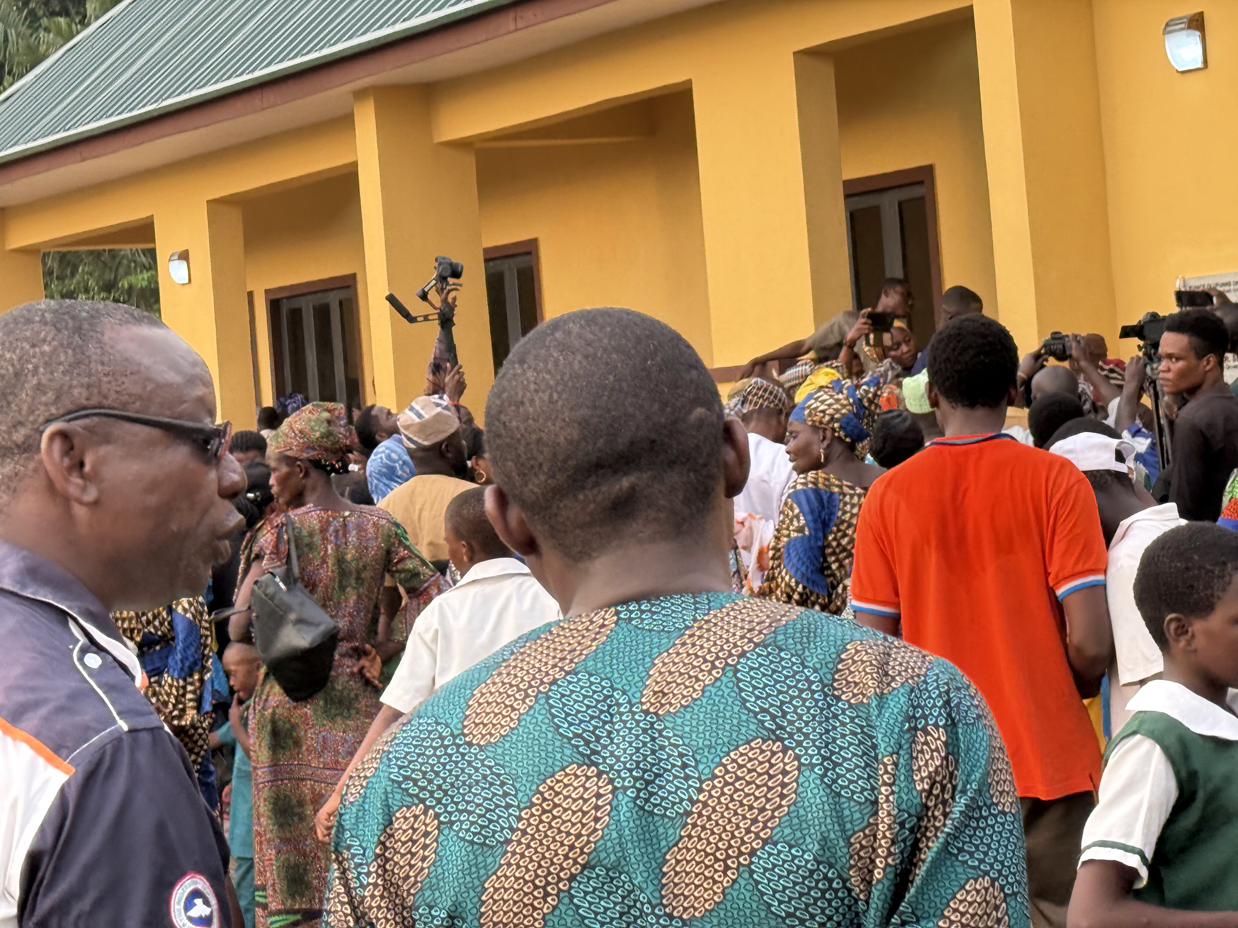 Commissioning ceremony &mdash; community gathered outside the hall, November 2024