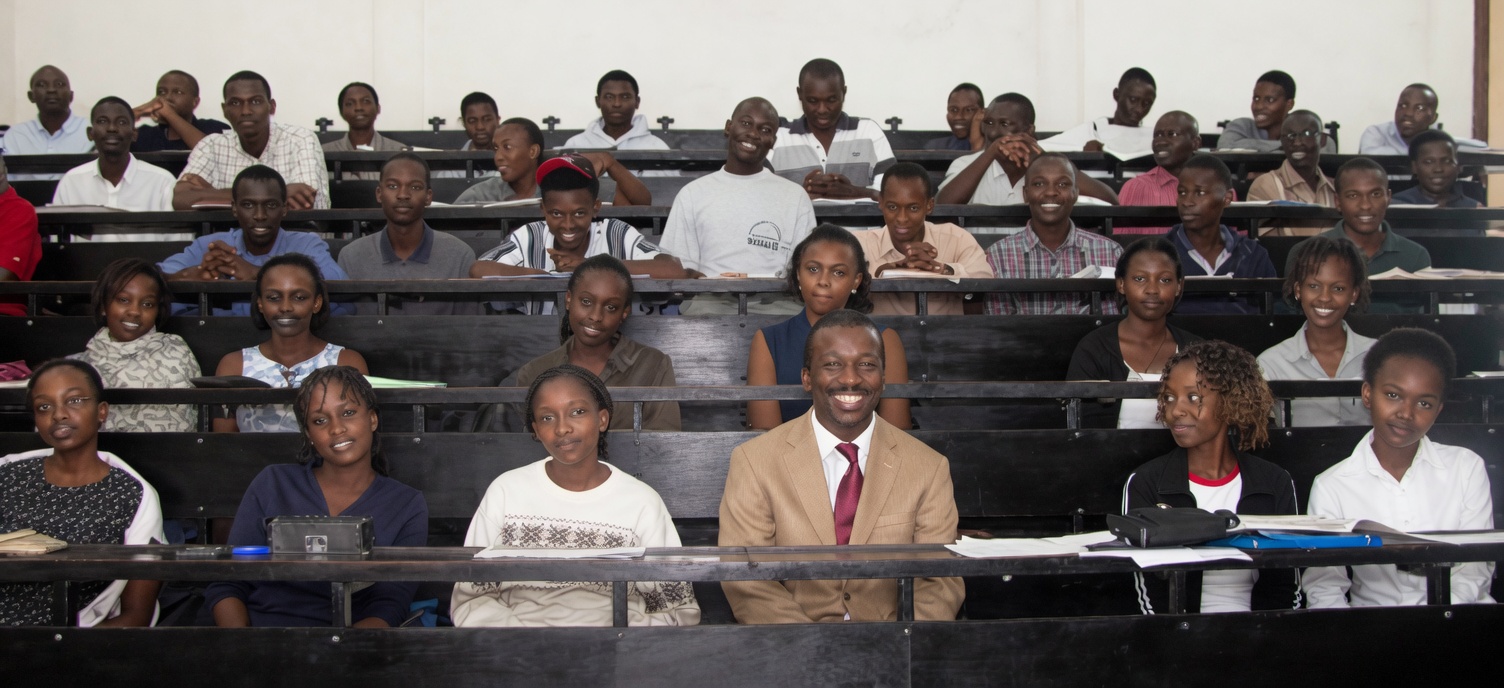 Olawale Opayinka seated among actuarial science students in a full lecture hall at the University of Nairobi, Kenya